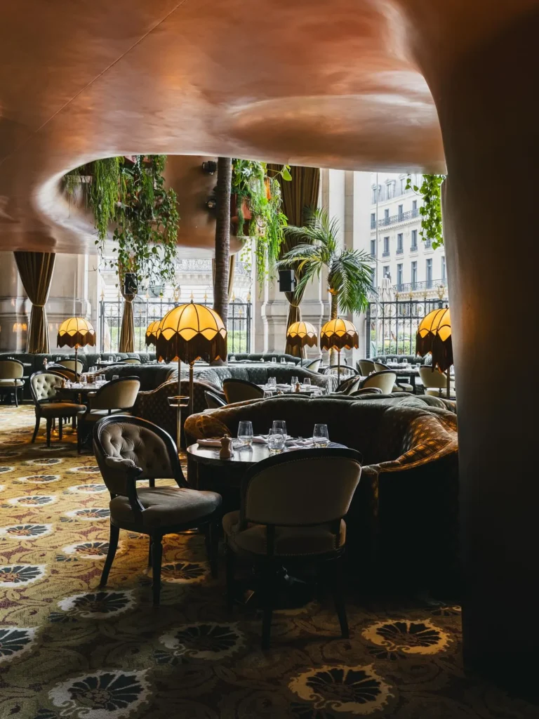 Warmly lit lounge and dining area inside BeauCoCo Paris