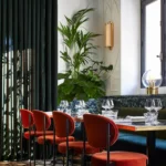 Elegant dining corner with red chairs at Beefbar Paris