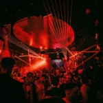 Red-lit club interior filled with guests at Boum Boum Paris