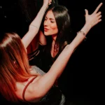 Guests dancing together inside Boum Boum Paris nightclub