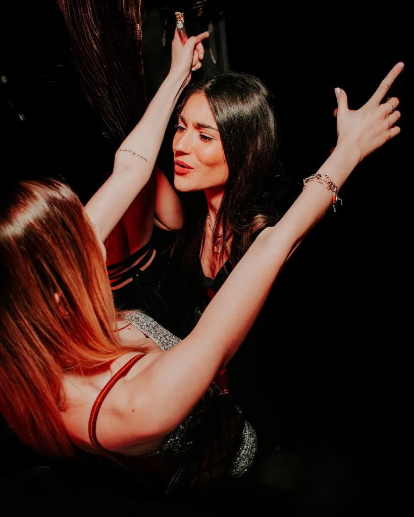 Guests dancing together inside Boum Boum Paris nightclub