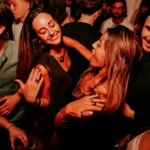 Guests enjoying the nightlife atmosphere at Boum Boum Paris