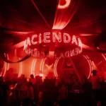 Red-lit nightclub scene at Boum Boum Paris