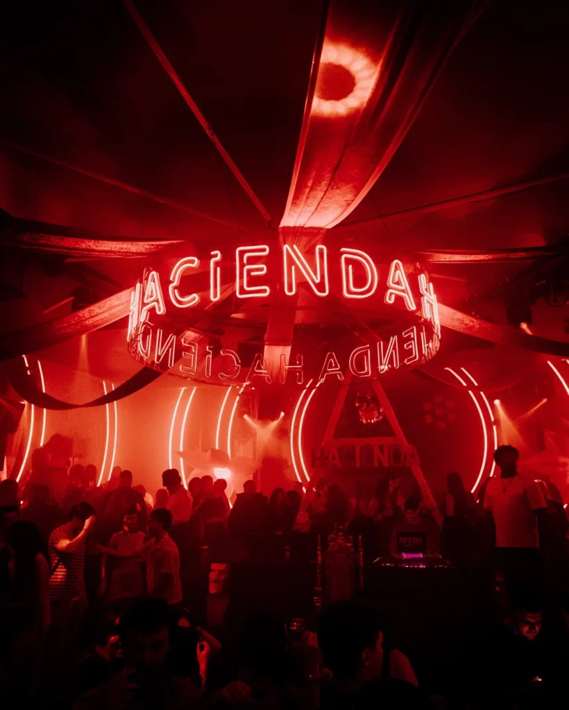 Red-lit nightclub scene at Boum Boum Paris
