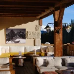 Covered lounge seating with alpine views at Chalet de Pierres Courchevel