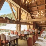 Elegant dining room with panoramic mountain views at Chalet de Pierres Courchevel