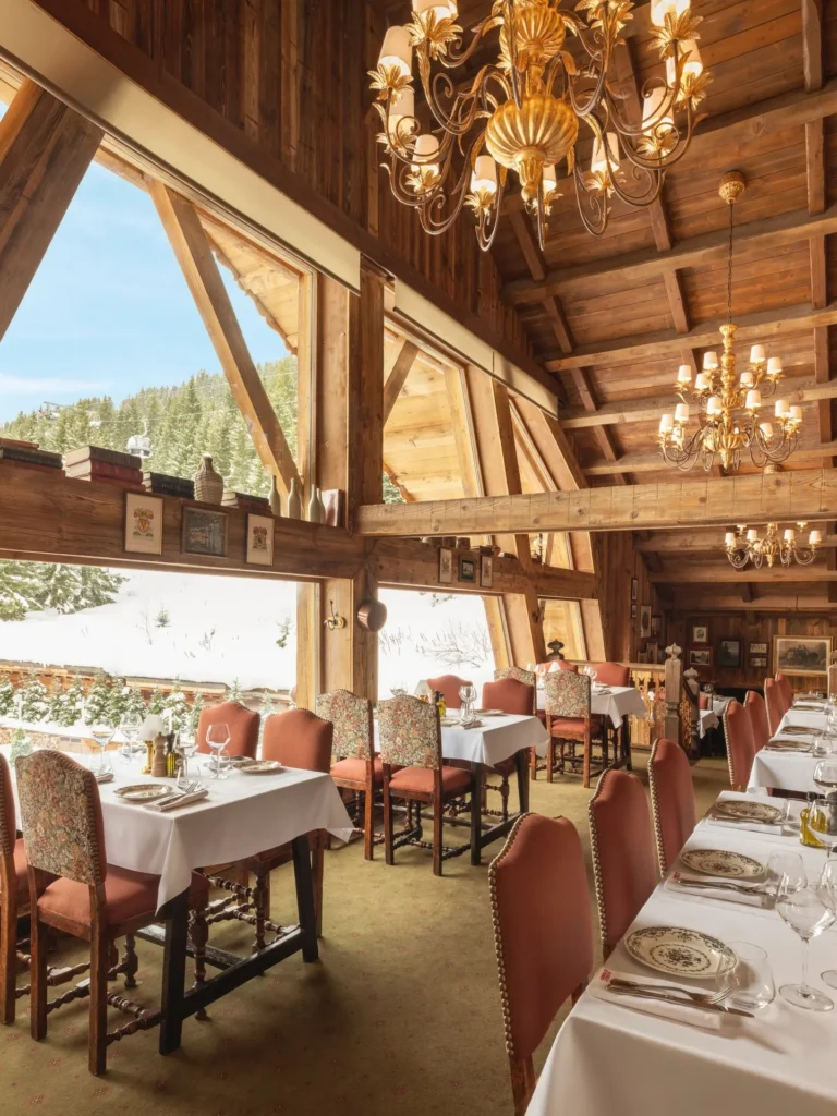 Elegant dining room with panoramic mountain views at Chalet de Pierres Courchevel