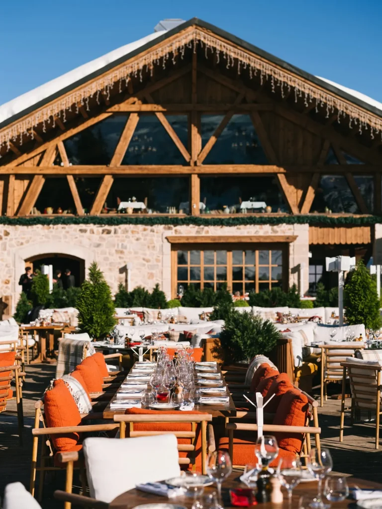 Guests dining on the outdoor terrace at Chalet de Pierres Courchevel