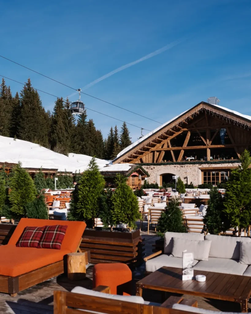Outdoor dining terrace at Chalet de Pierres surrounded by alpine scenery