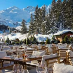 Outdoor terrace dining area with snowy mountain views at Chalet de Pierres