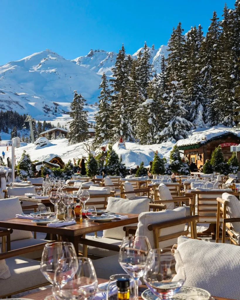 Outdoor terrace dining area with snowy mountain views at Chalet de Pierres