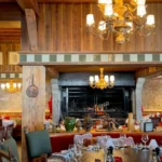 Rustic dining room with wooden interiors at Chalet de Pierres Courchevel