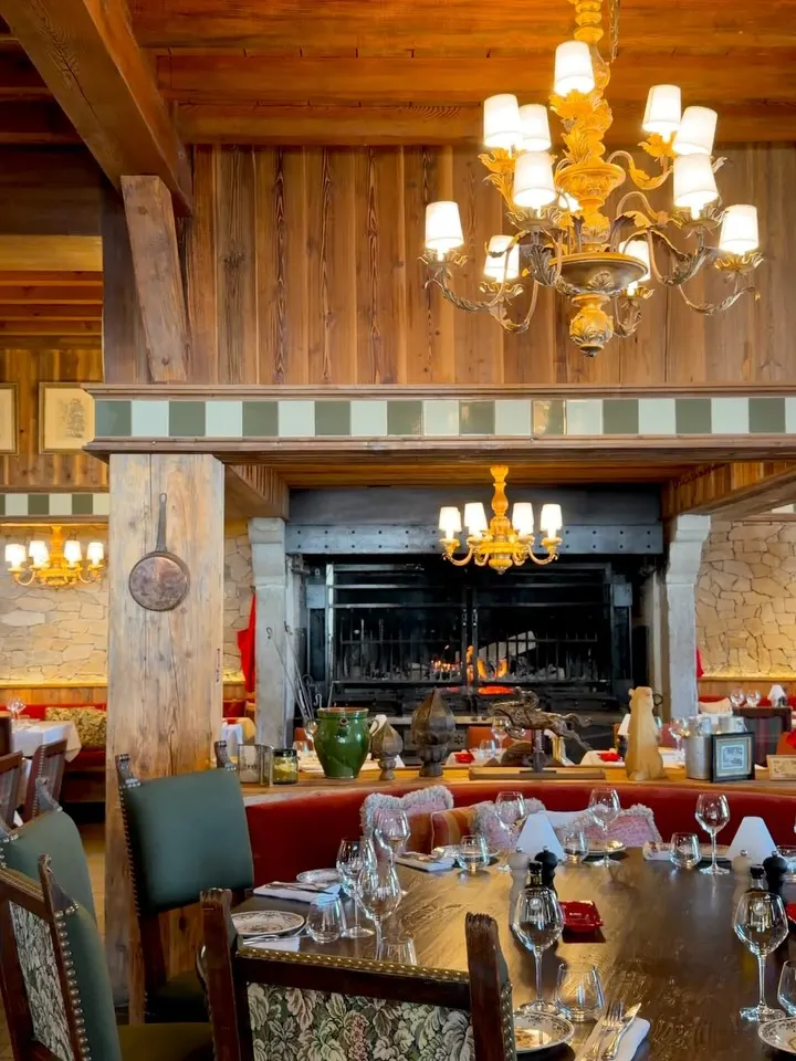 Rustic dining room with wooden interiors at Chalet de Pierres Courchevel