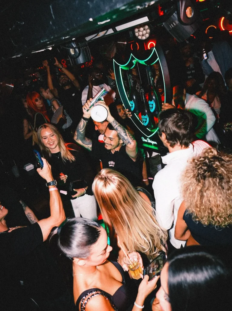 Guests dancing and celebrating inside Deflower Paris nightclub