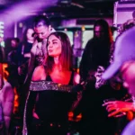 Guest enjoying the colorful club atmosphere at Deflower Paris