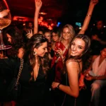 Guests dancing together on the crowded dance floor at Deflower Paris
