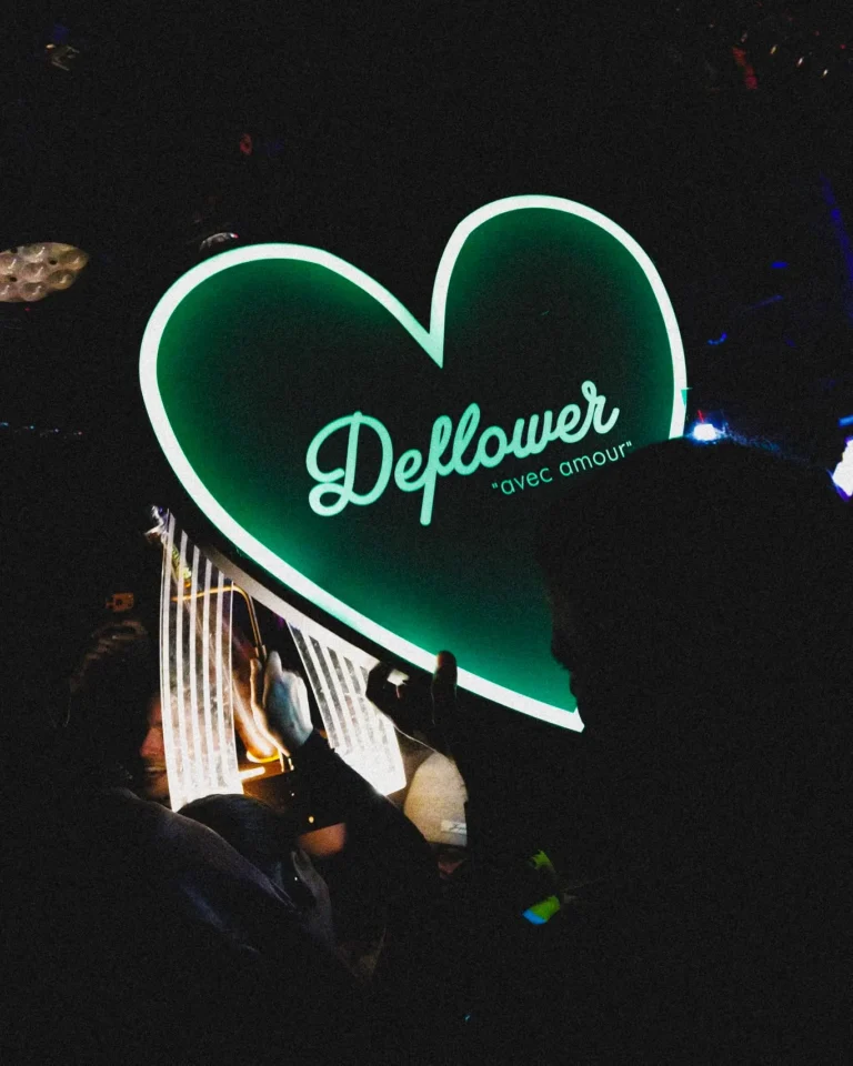 Illuminated Deflower neon sign inside the Paris nightclub