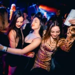 Guests dancing and celebrating at a Deflower Paris nightclub party