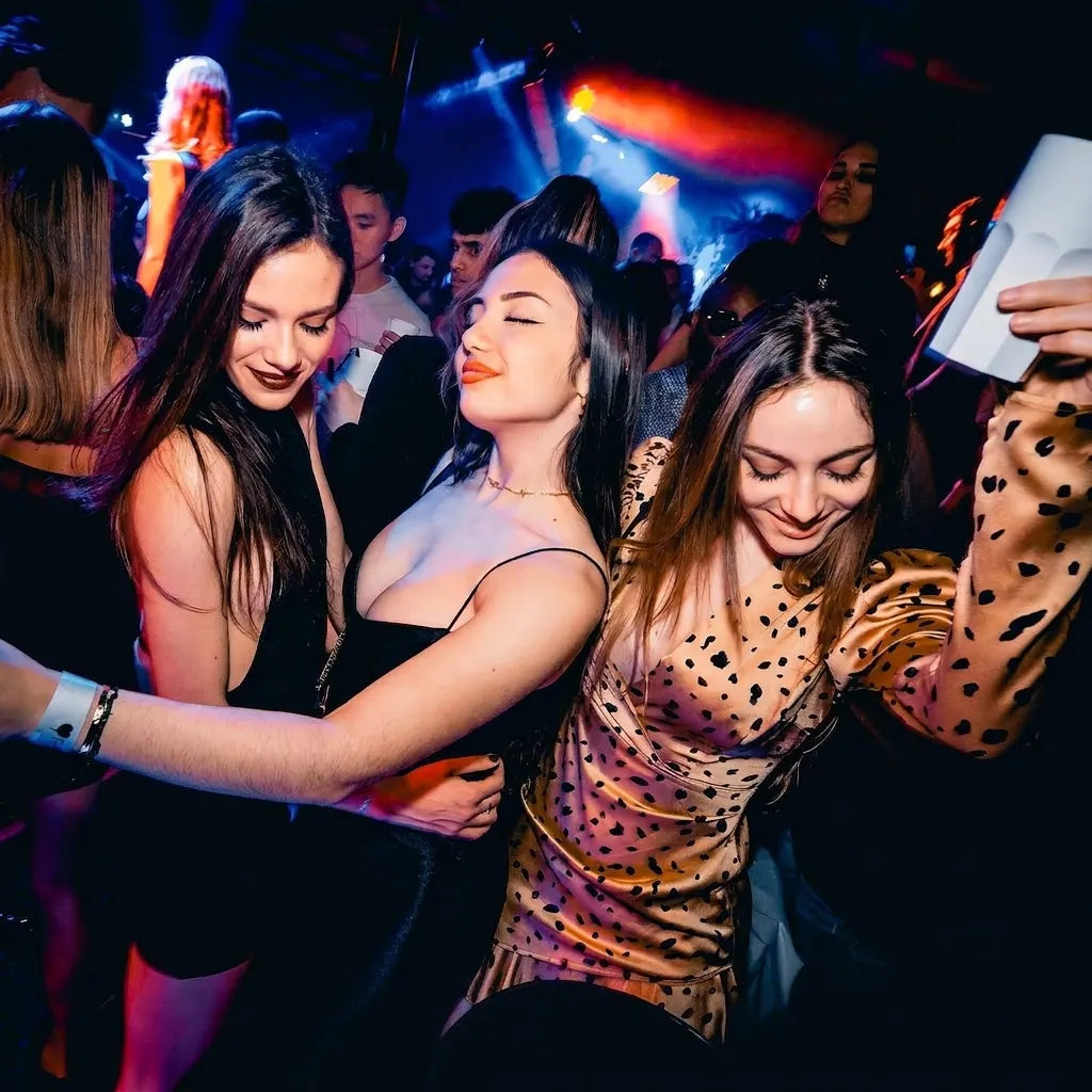 Guests dancing and celebrating at a Deflower Paris nightclub party