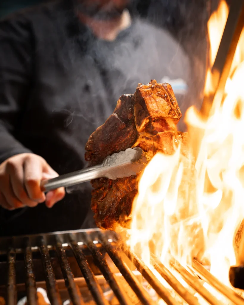 Argentine grilled meat being prepared at El Porteño Prohibido