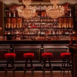 Elegant bar interior with chandeliers at El Porteño Prohibido