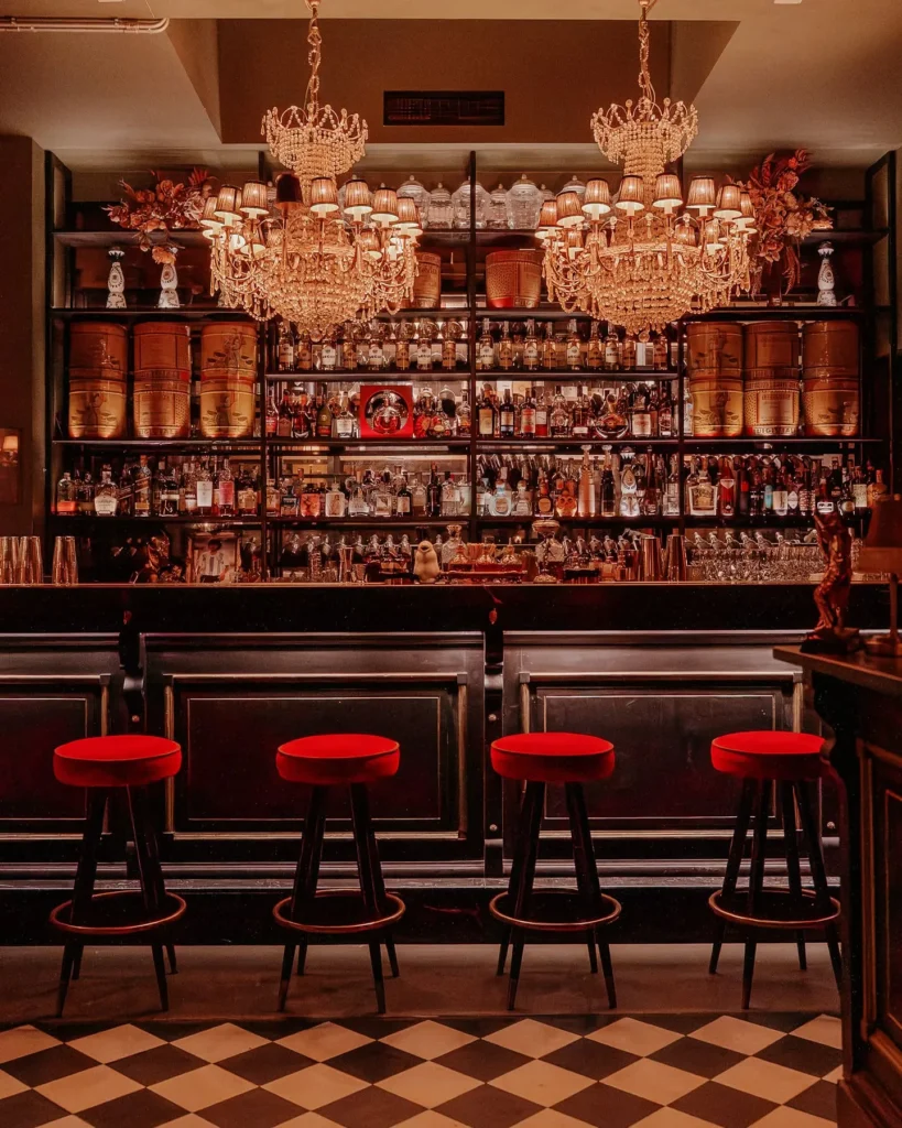 Elegant bar interior with chandeliers at El Porteño Prohibido