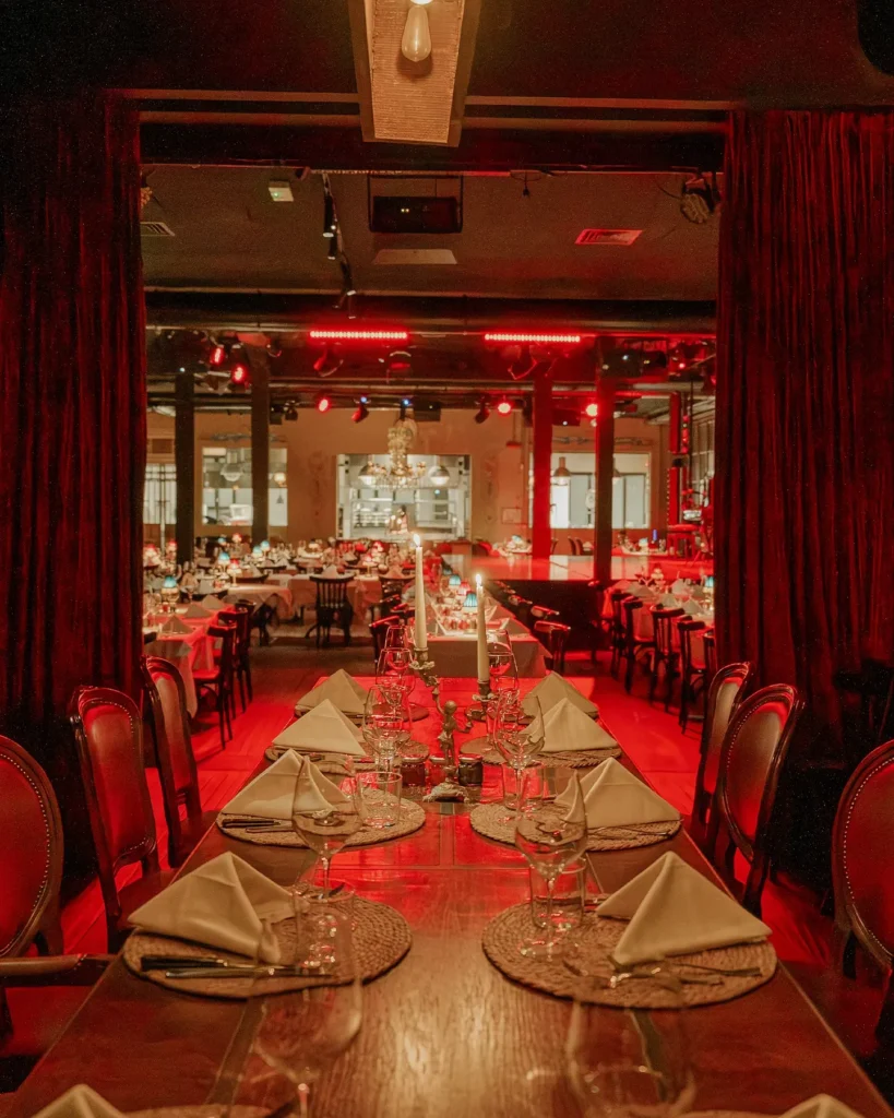 Elegant red-lit dining room at El Porteño Prohibido