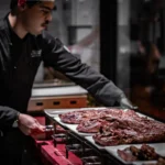 Chef preparing grilled Argentine meat at El Porteño Prohibido