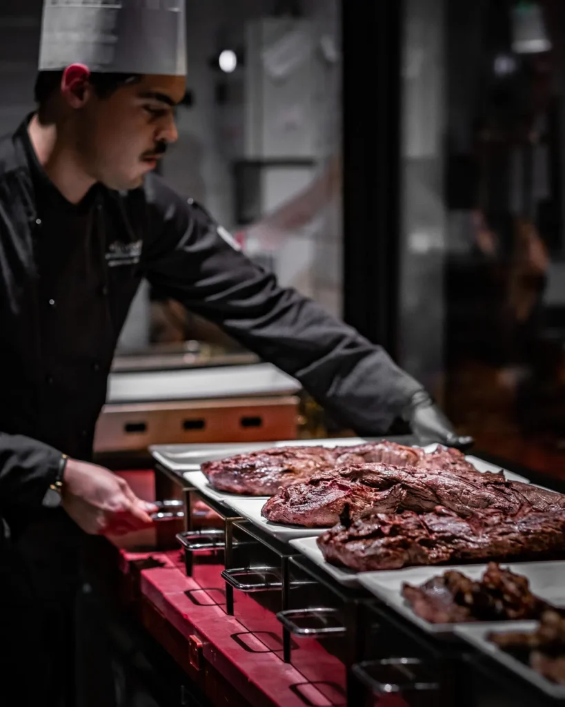 Chef preparing grilled Argentine meat at El Porteño Prohibido