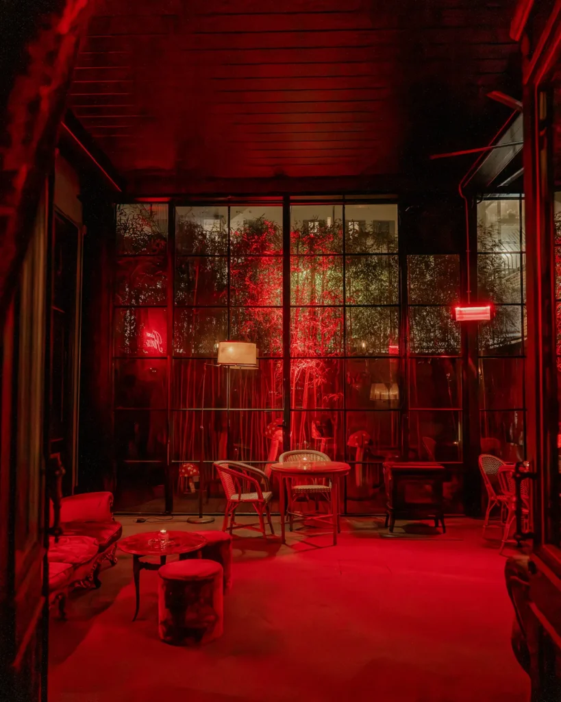 Red-lit lounge and seating area at El Porteño Prohibido