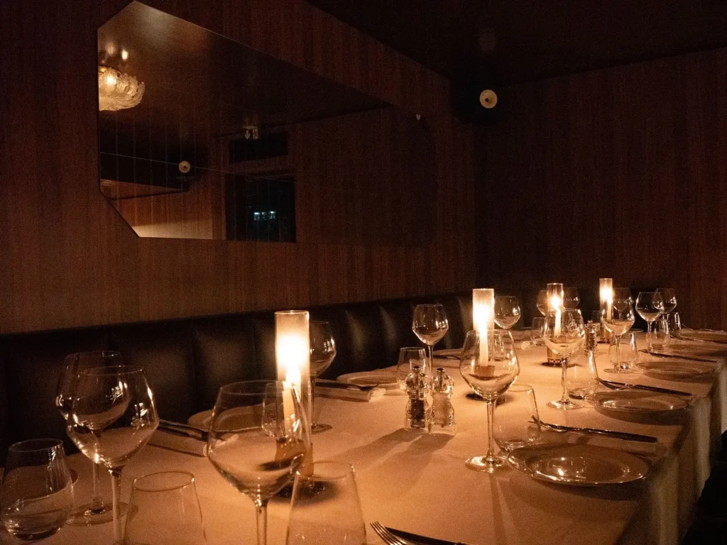 Candlelit dining tables in the intimate interior of Giulia Ristorante Paris