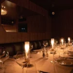 Candlelit dining tables in the intimate interior of Giulia Ristorante Paris