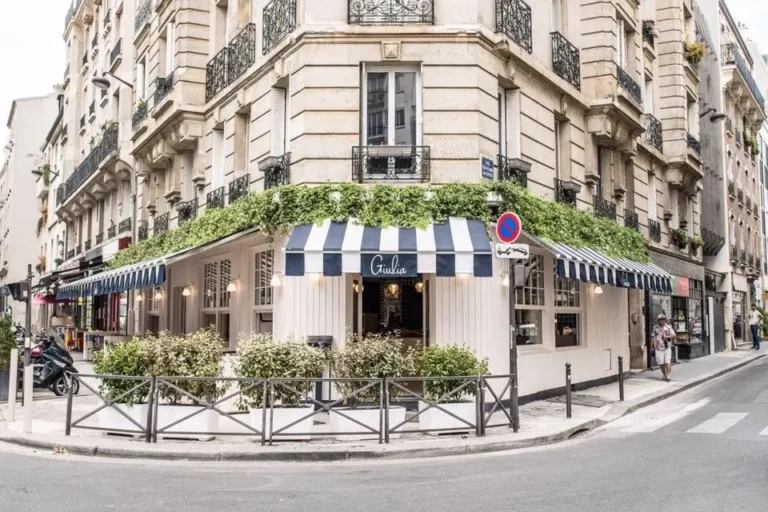 Giulia Ristorante Paris exterior with striped awning and outdoor seating