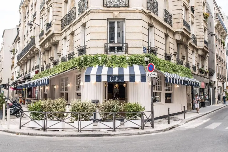Giulia Ristorante Paris exterior with striped awning and outdoor seating