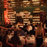 Warmly lit dining room inside Giulia Ristorante Paris