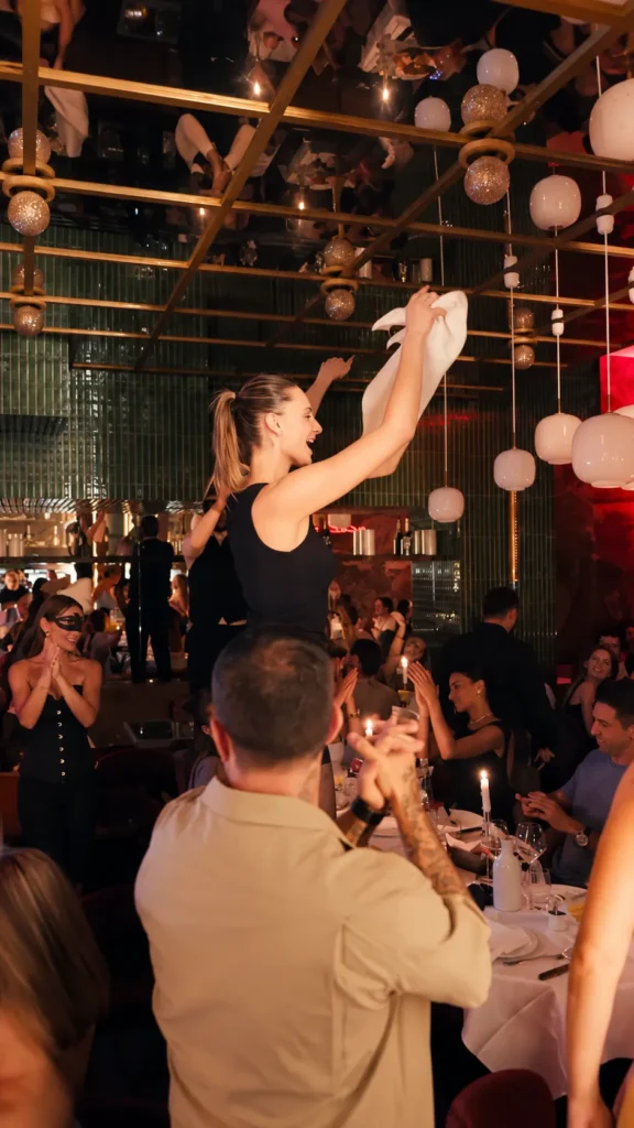 Guest dancing among diners during an evening at Giulia Ristorante Paris