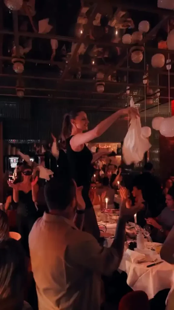Guests enjoying a lively evening inside Giulia Ristorante Paris