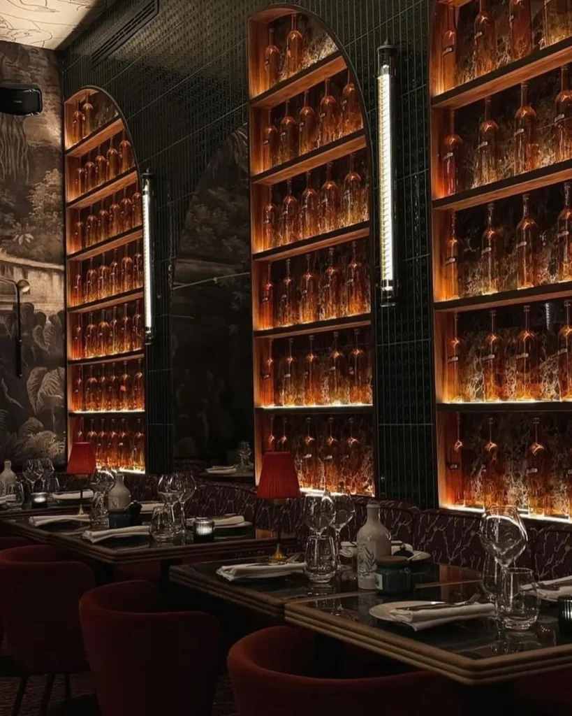 Wine bottles displayed in the elegant dining room at Giulia Ristorante Paris