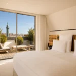 Luxury bedroom with a panoramic Paris view at Hotel Costes