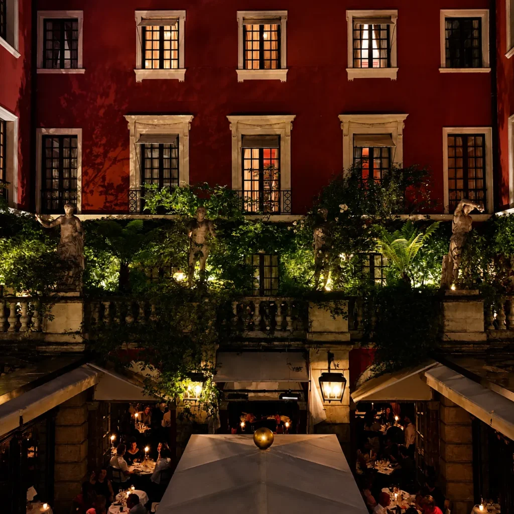 Hotel Costes courtyard restaurant surrounded by classic Parisian architecture