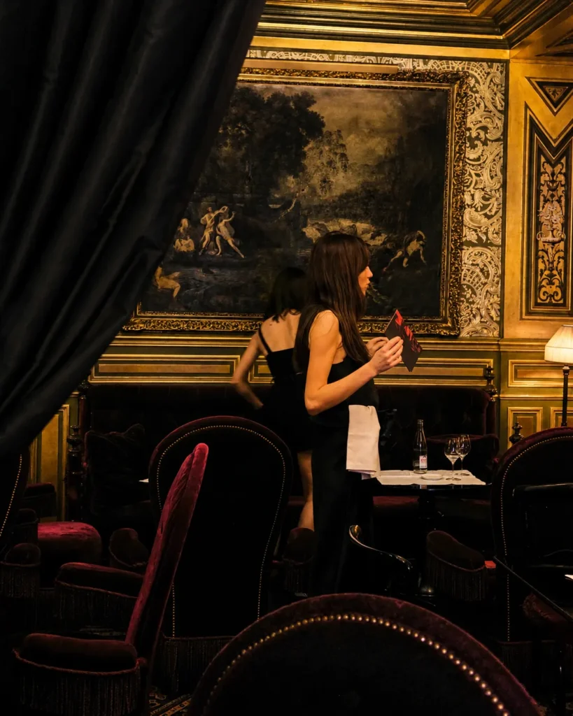 Elegant dining interior with classic artwork at Hotel Costes