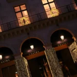 Hotel Costes facade illuminated at night in Paris