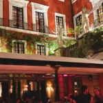 Historic red facade and restaurant entrance at Hotel Costes in Paris