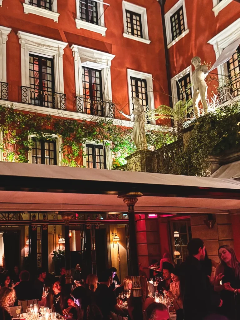 Historic red facade and restaurant entrance at Hotel Costes in Paris