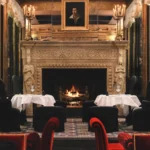 Elegant dining room with a fireplace at Hotel Costes in Paris
