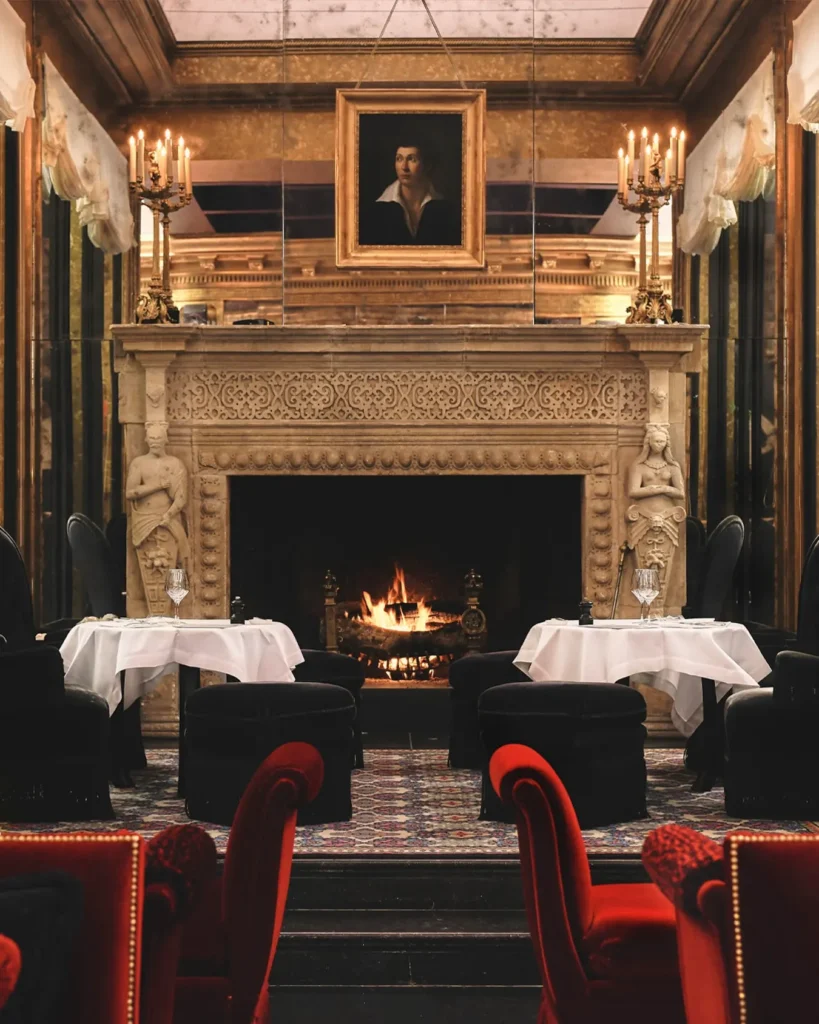 Elegant dining room with a fireplace at Hotel Costes in Paris