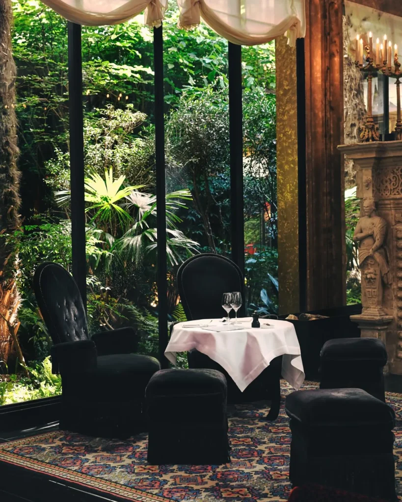 Garden-facing dining room at Hotel Costes in Paris