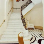 Grand white staircase with ornate details at Hotel Costes Paris