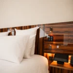 Luxury bed and elegant wood-paneled interior at Hotel Costes Paris