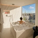 Elegant marble bathroom with a city view at Hotel Costes Paris
